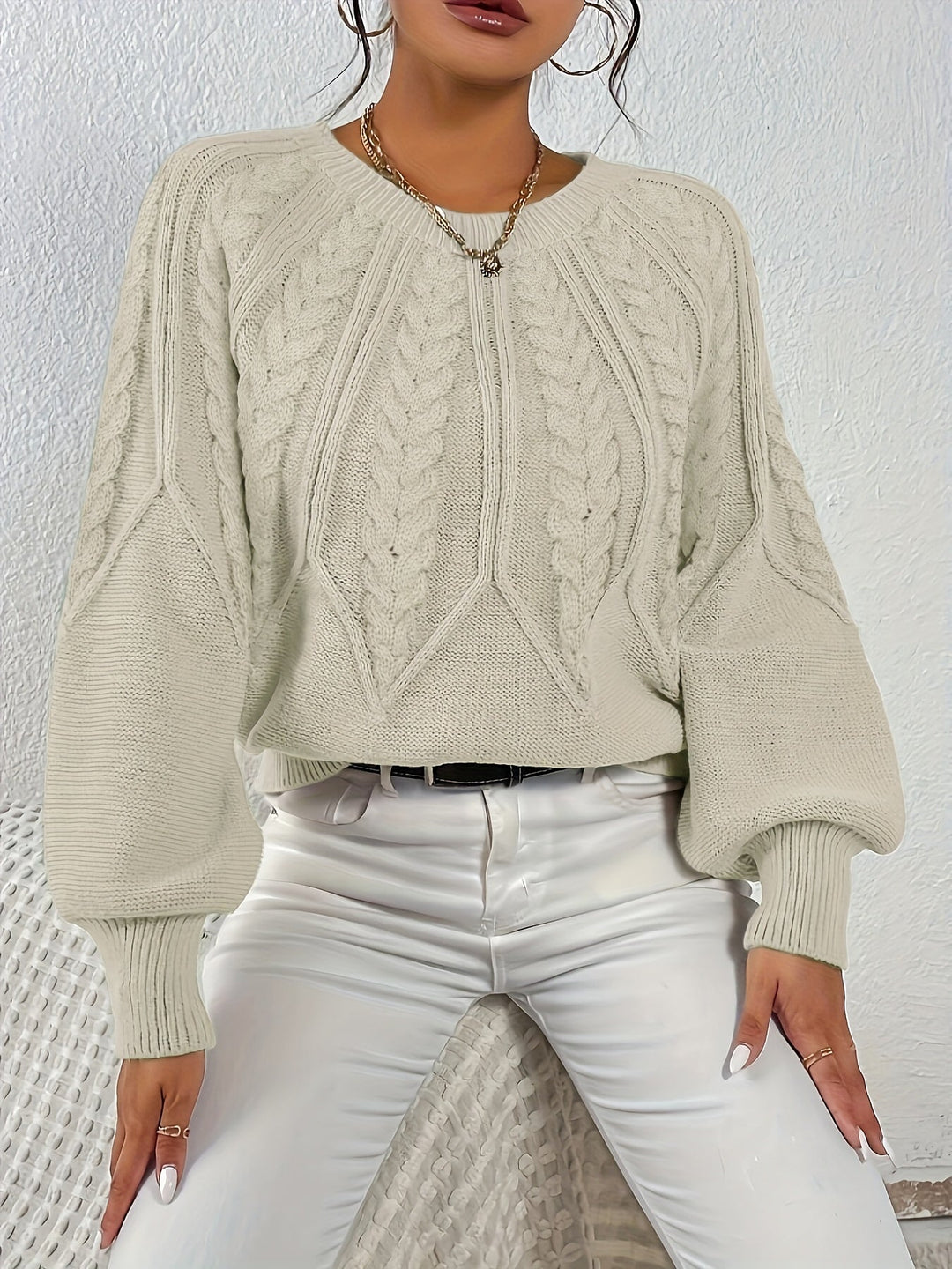 Long sleeve cable knit sweater for women, relaxed fit, with fashionable lantern sleeves.