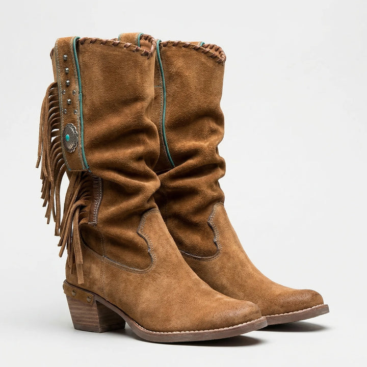 Fashionable women's mid-calf boots. Fringe details, western flair, pointed toe, and block heel.