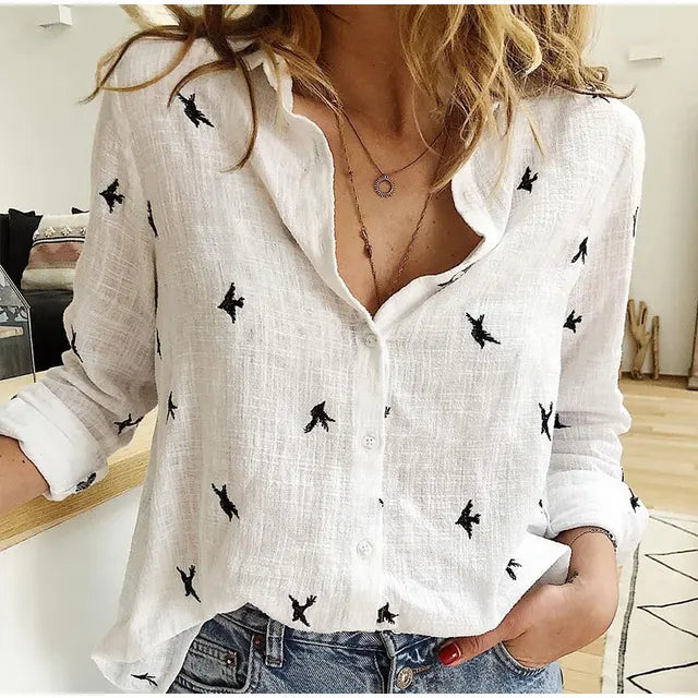 Printed long-sleeve women's button-up blouse featuring a unique bird design, great for vacation or casual outings.