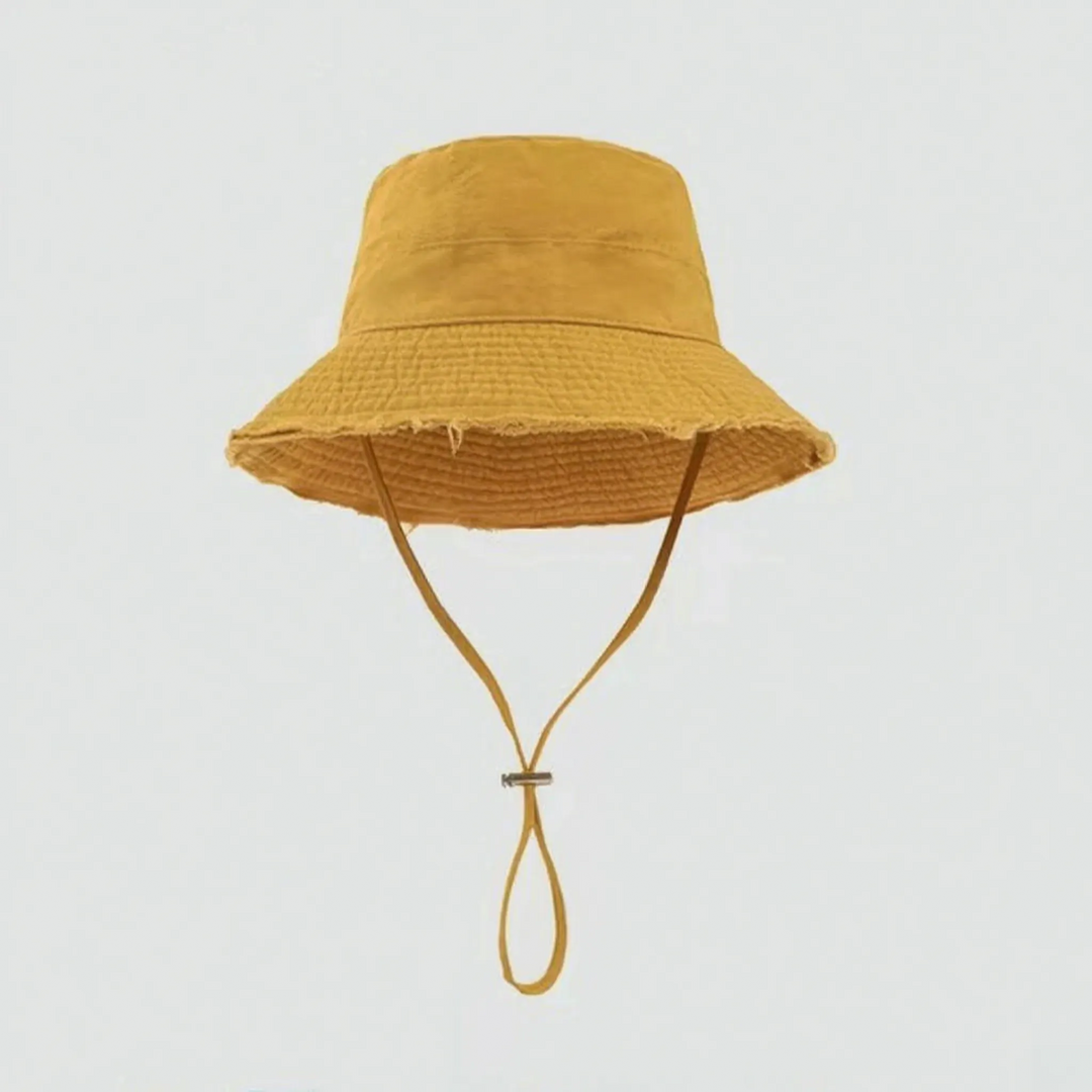 Sun protection bucket hat for women, frayed brim, adjustable strap, versatile summer wear.
