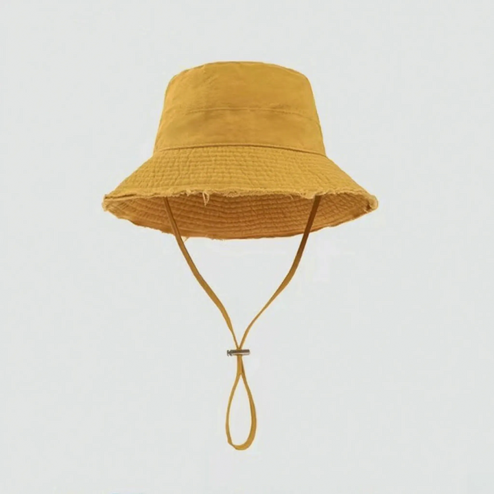 Sun protection bucket hat for women, frayed brim, adjustable strap, versatile summer wear.