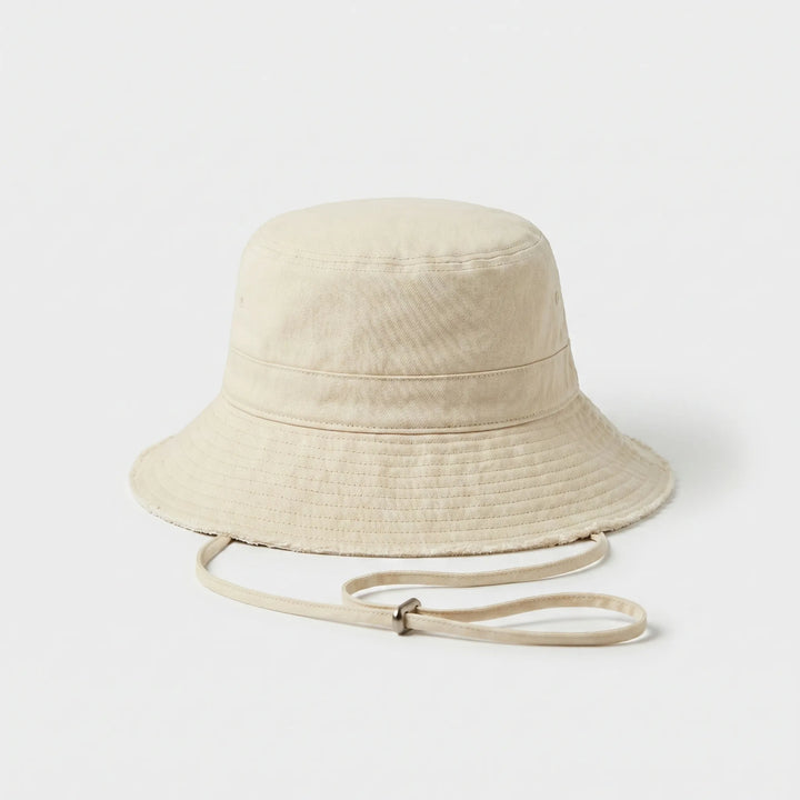 Foldable women's bucket hat with adjustable strap, ideal for travel, beach, and sun protection.