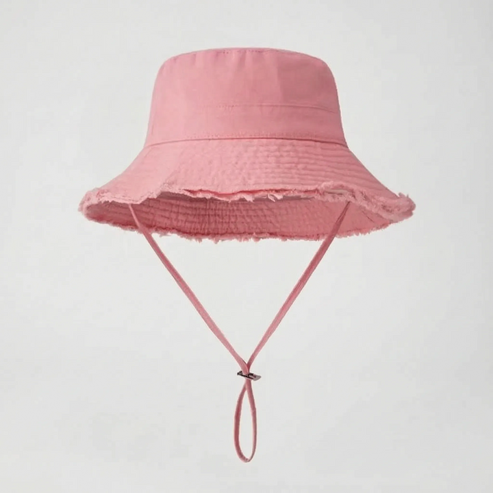 Women's travel bucket hat, adjustable chin strap, foldable, perfect for casual sun protection.
