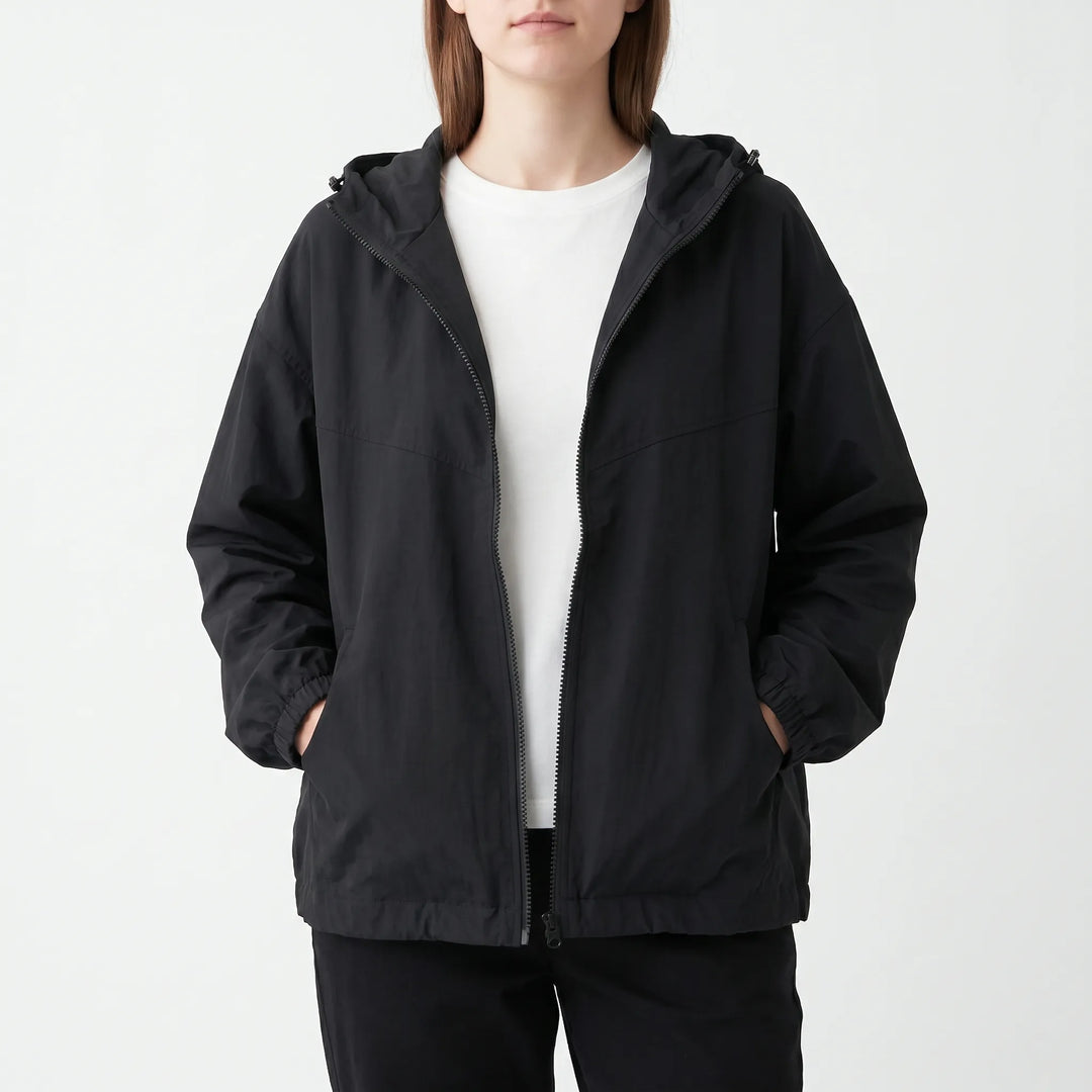 Versatile women's hooded windbreaker, ideal for transitional weather. Lightweight, everyday casual jacket for comfort.