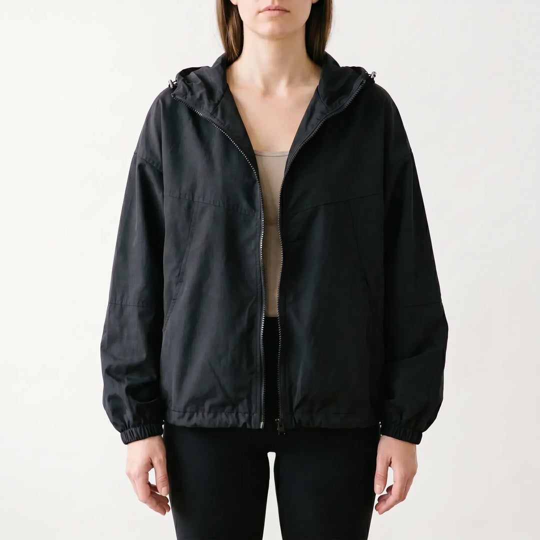 Stylish women's hooded windbreaker jacket in a casual design. Everyday outerwear offering comfort & light protection.