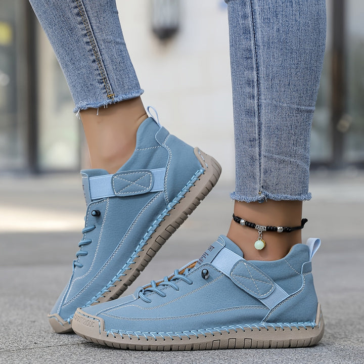 Fashionable women's casual sneakers with a stitched low-top profile and comfortable everyday design.