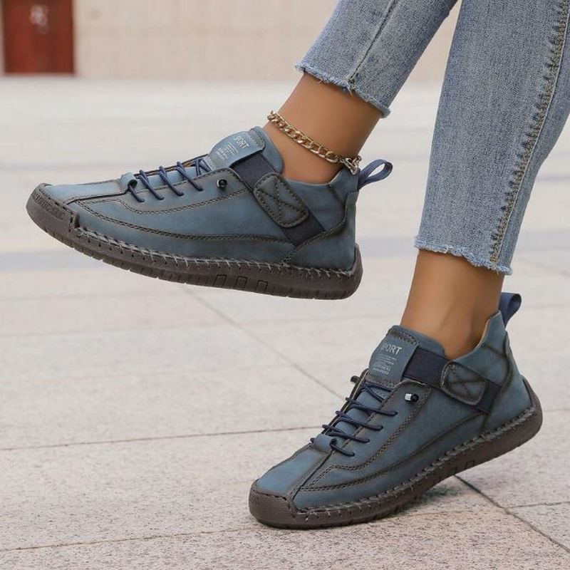 Casual stitched lace-up sneakers for women, offering comfortable low-top footwear for versatile fashion.