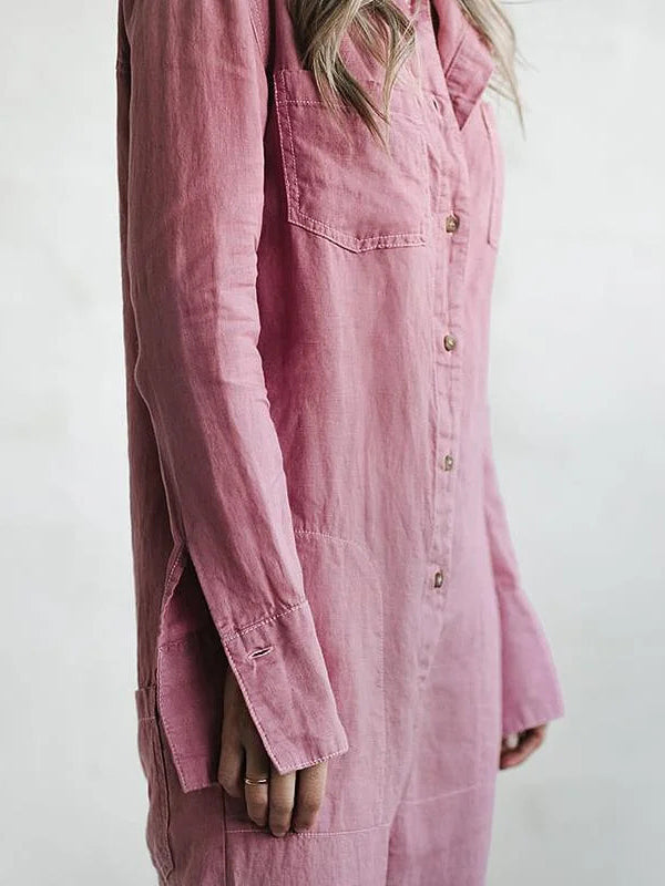 Woman wearing a casual long sleeve button-up jumpsuit. Comfortable & relaxed fit for everyday activities.