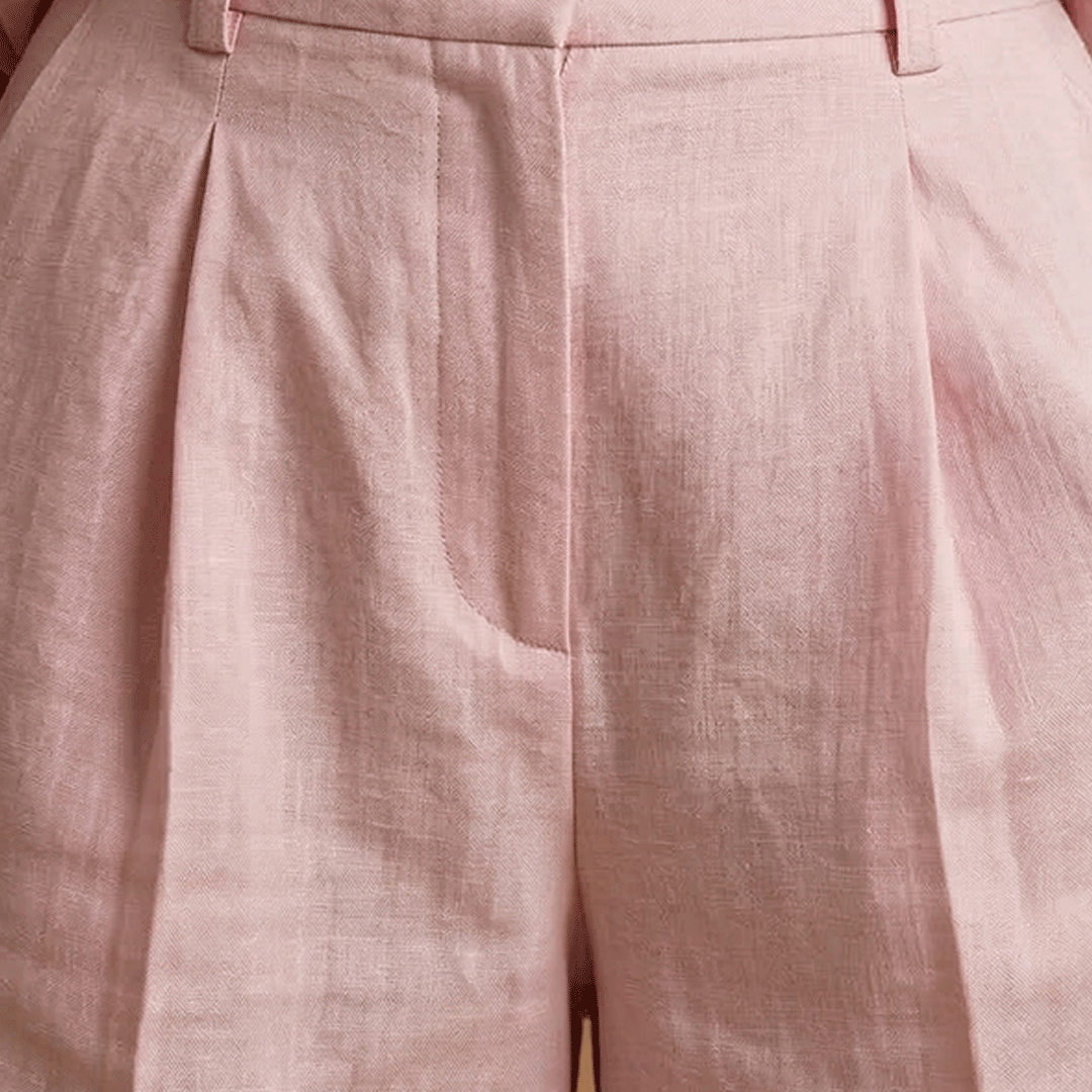 Women's elegant long sleeve shirt and casual shorts set, perfect for a chic summer travel look.