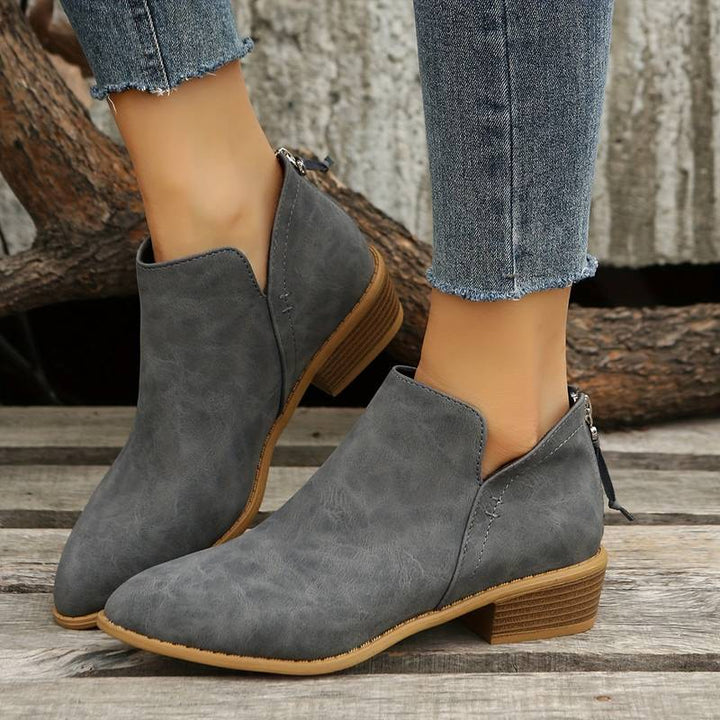 Comfortable women's slip-on boots with a low heel, offering chic and modern casual everyday footwear.