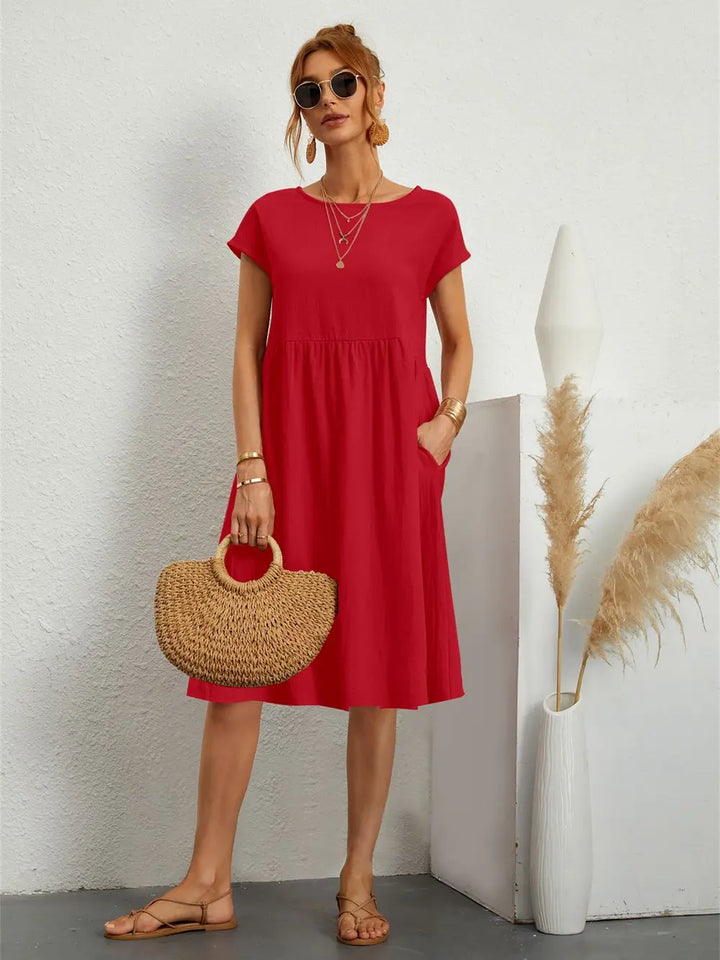 Women's casual midi dress with short sleeves & practical pockets, ideal for comfortable everyday wear.