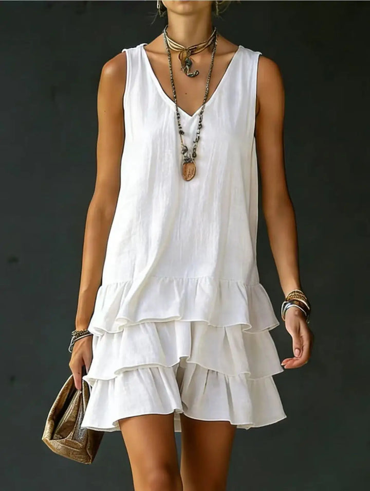 Playful women's sleeveless V-neck mini dress with ruffle tiers, ideal for warm weather and relaxed fit.