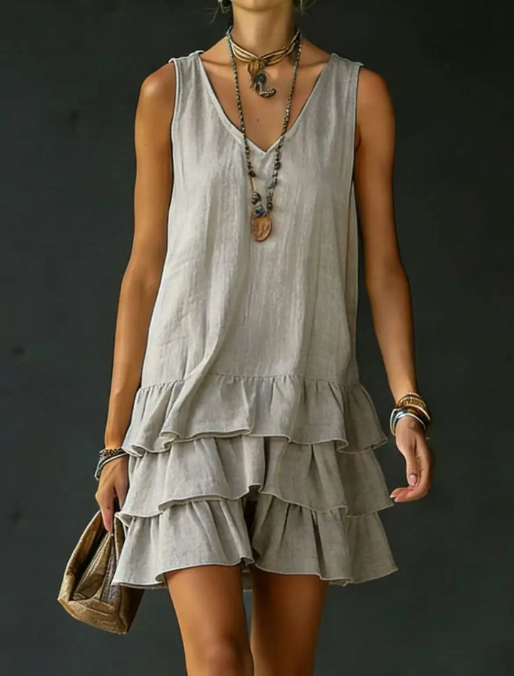 Vacation-ready women's sleeveless mini dress. Features a flattering V-neck and pretty ruffle tiered design.