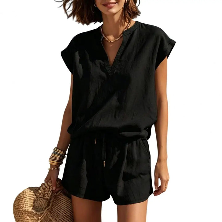 Chic women's resort wear co-ord set. V-neck top and drawstring shorts for a casual summer vacation outfit. Two-piece.