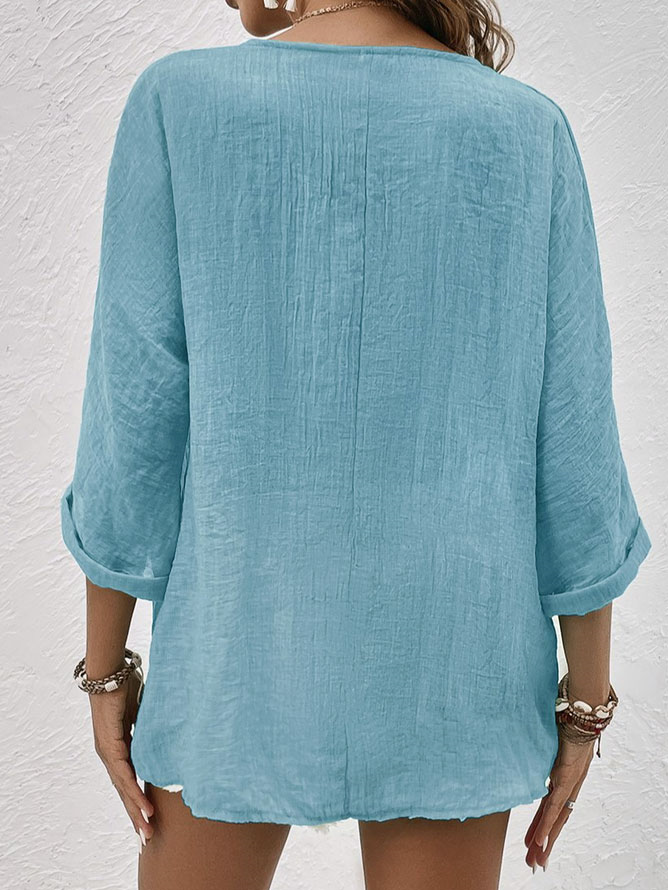 Relaxed fit women's V-neck blouse, a versatile long sleeve button down top for casual spring and summer fashion.