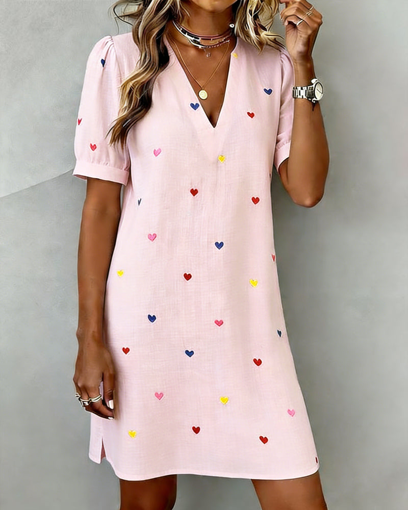 Relaxed fit women's V-neck dress featuring charming heart print & puff sleeves. Great for casual comfort.