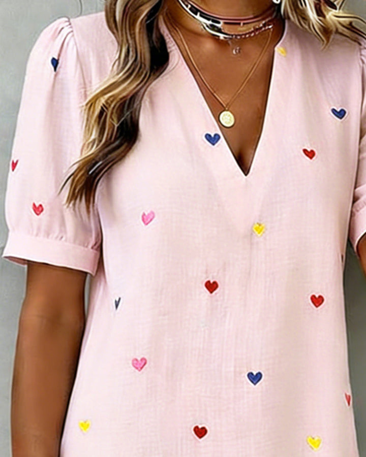 Cute heart print V-neck mini dress for women. Casual summer style with puff sleeves & comfortable fit.
