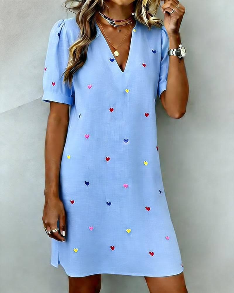 V-neck mini dress for women, featuring a vibrant heart print & playful puff sleeves. Casual & comfortable.