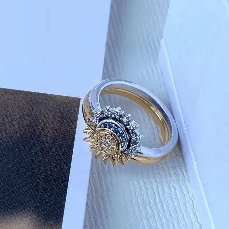 Unique women's silver-tone celestial ring with intricate sun & moon design, sparkling cosmic charm.