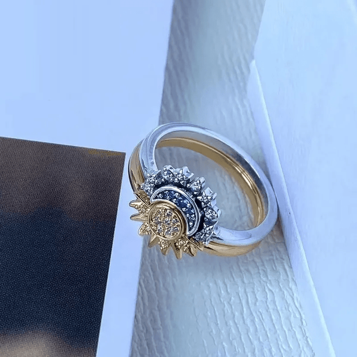 Unique women's silver-tone celestial ring with intricate sun & moon design, sparkling cosmic charm.
