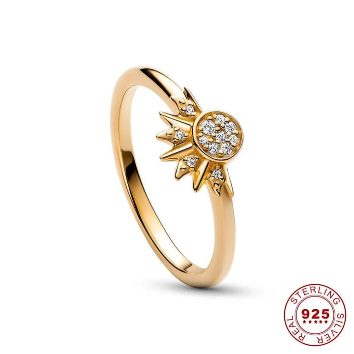 Close-up of a sparkling women's celestial sun & moon ring, unique design with silver-tone finish.