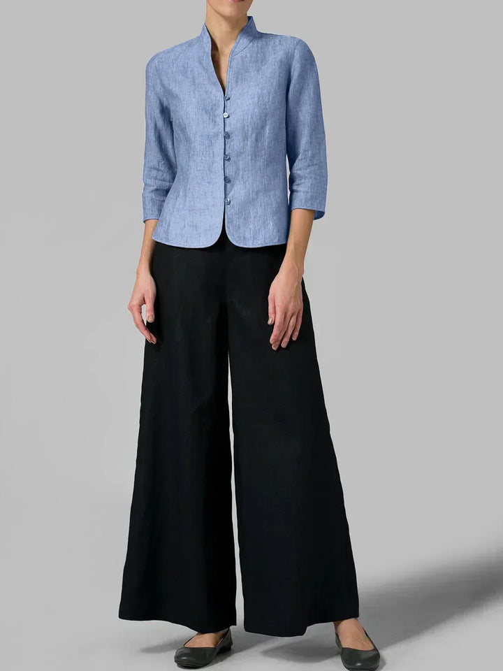 Close-up of a women's button-front blouse with 3/4 sleeves and a minimalist design, great for office or casual.