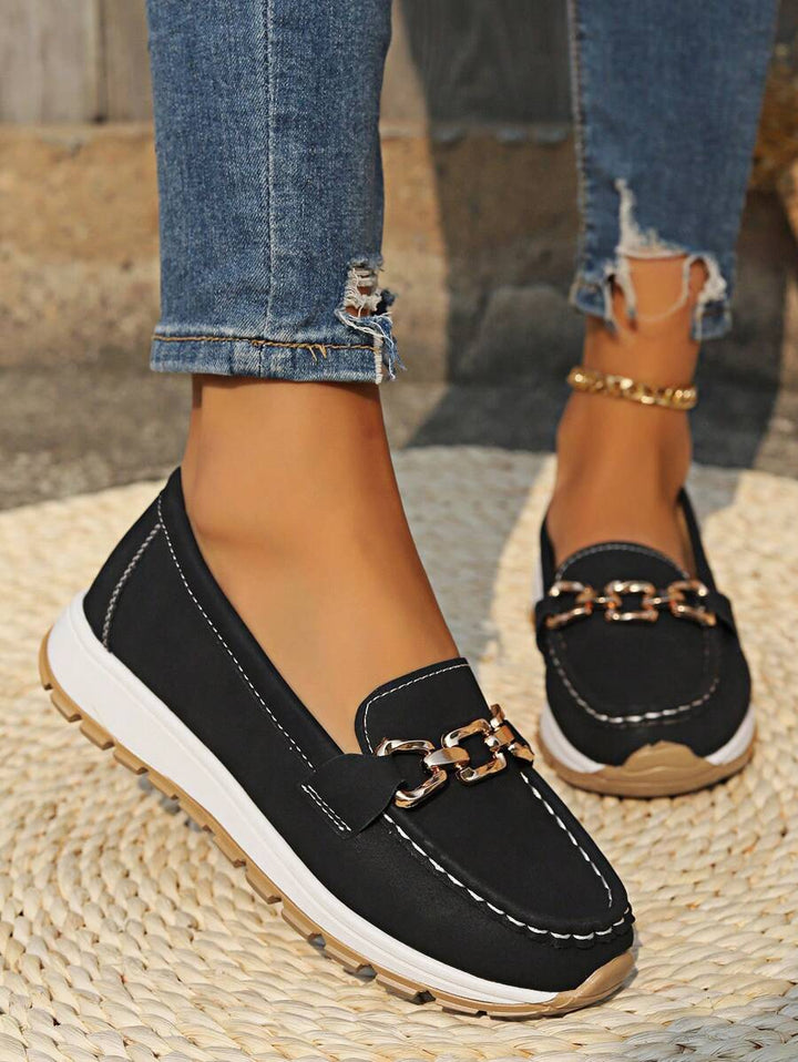Women's chic black flatform loafers with elegant gold chain trim, perfect for stylish everyday wear.