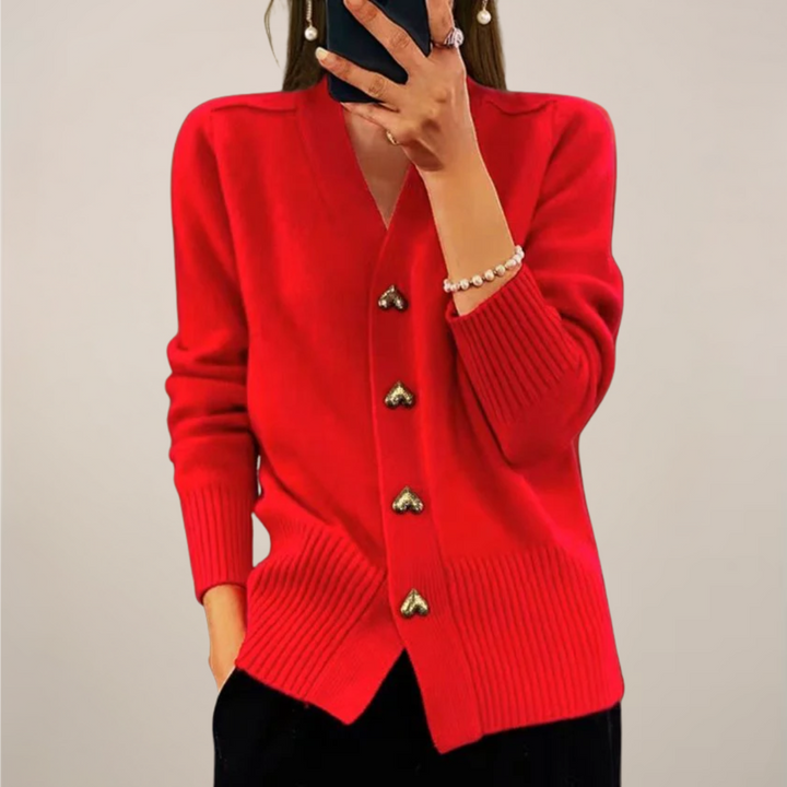 Cozy women's knit cardigan featuring unique gold heart buttons. A versatile long-sleeve layering top.
