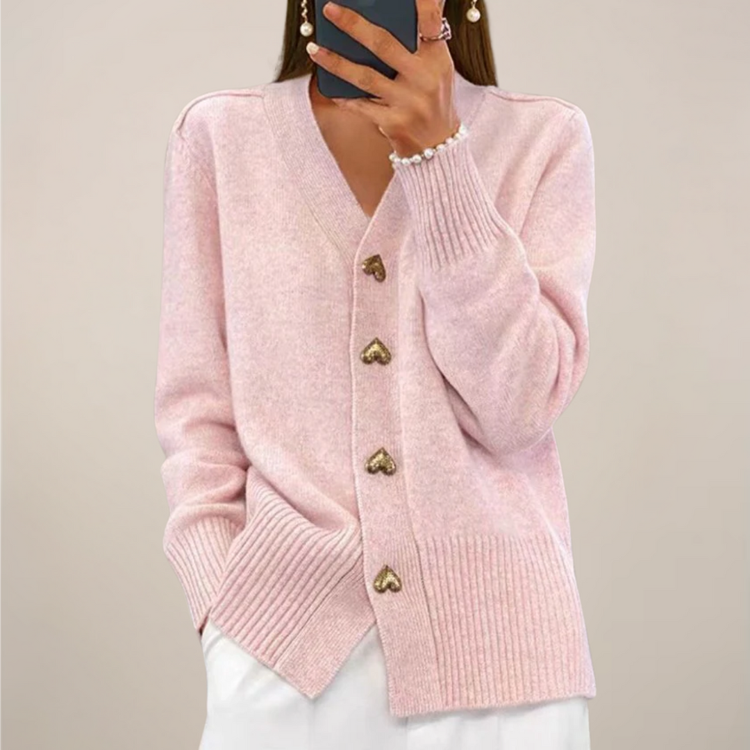 Casual chic women's cardigan with striking gold heart buttons. Relaxed fit, elegant layering piece.