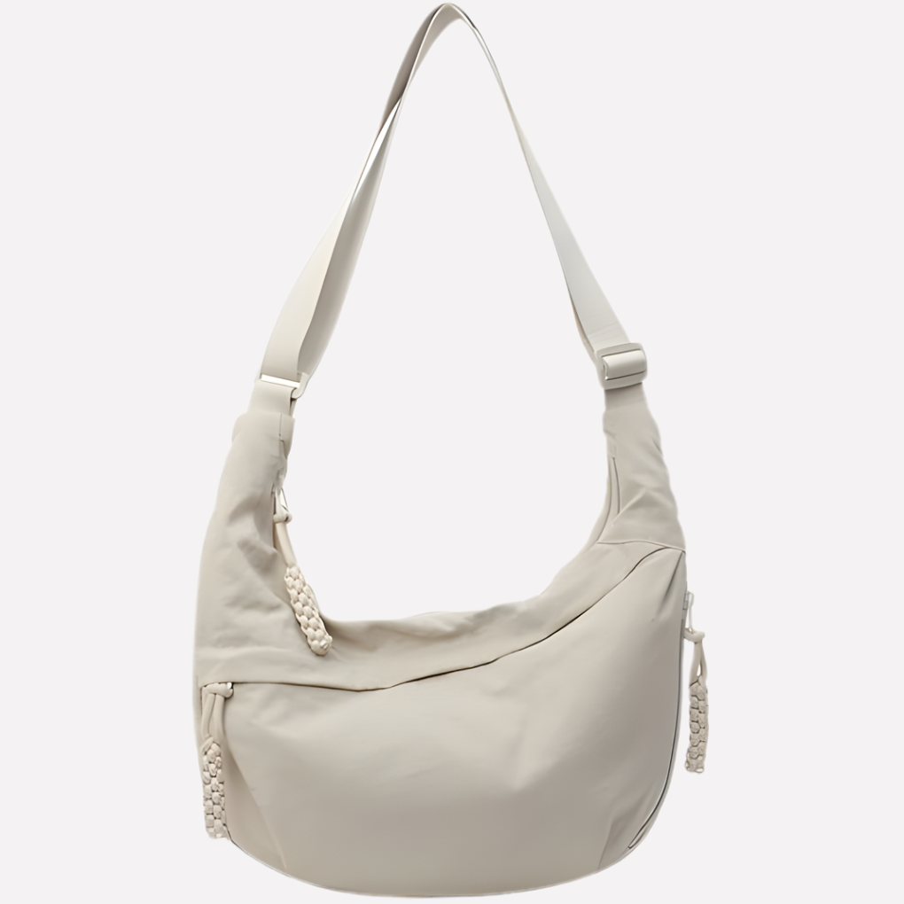Women's chic crescent shoulder bag with braided strap detail, perfect for everyday style.