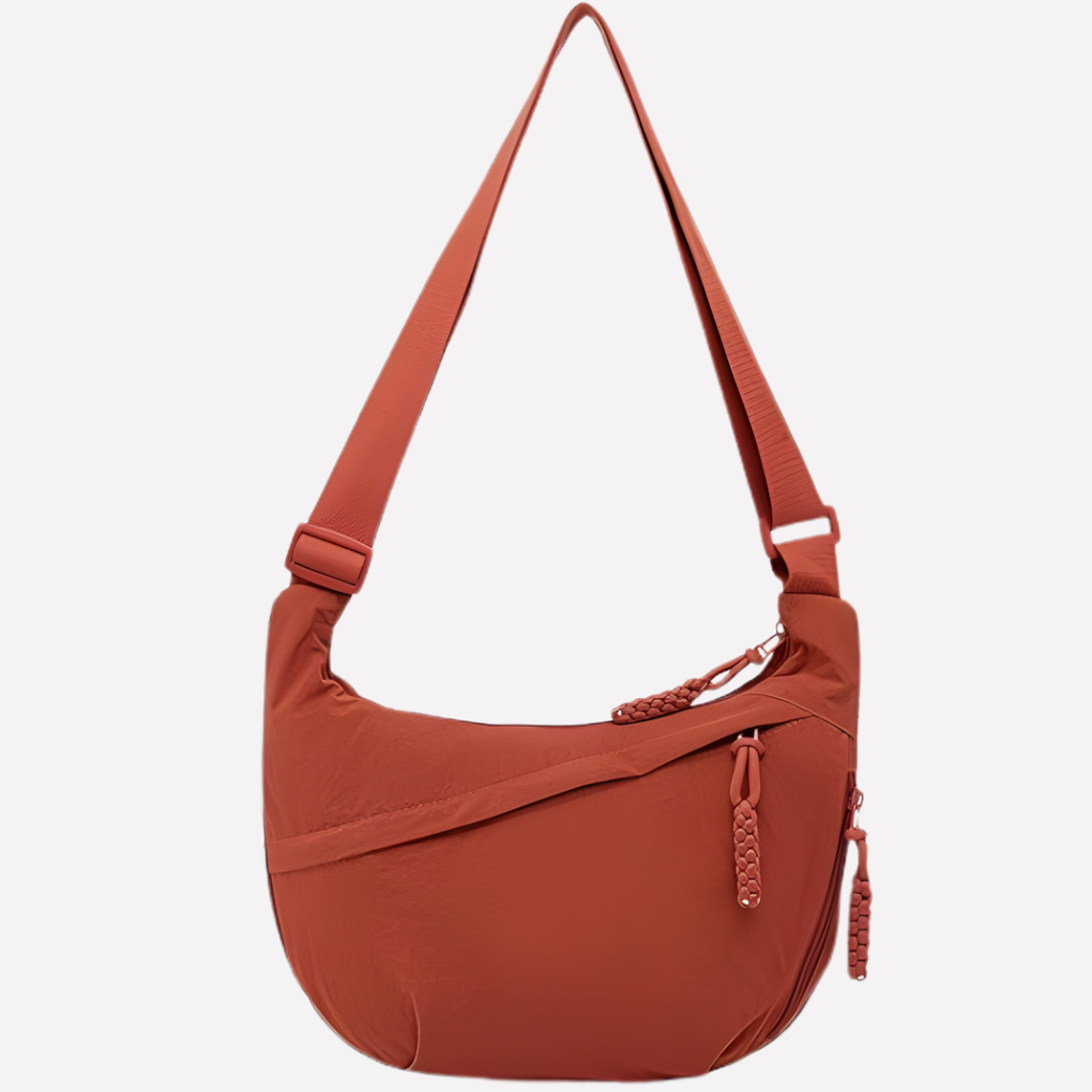 Versatile women's crescent crossbody bag with an eye-catching braided strap detail.
