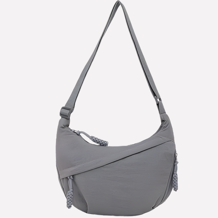 Sleek crescent shoulder bag for women, featuring a trendy braided strap and ample space.