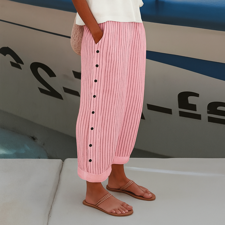 Stylish women's cropped pants with chic stripe and button design, offering elegant comfort for spring fashion.