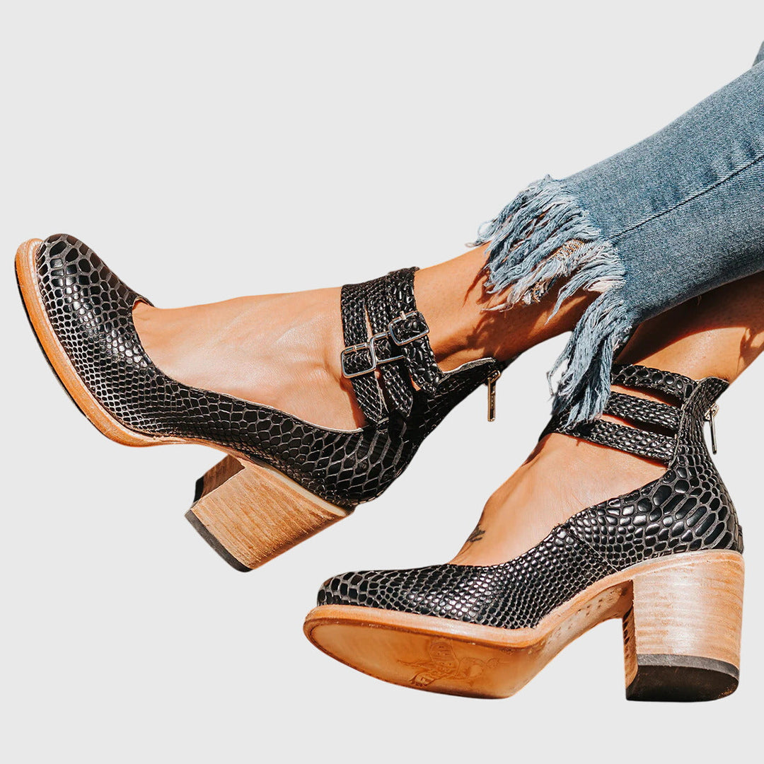 Women's chic cutout ankle boots with buckle & stable block heel. Perfect for versatile fashion footwear.