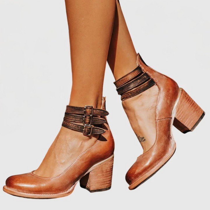 Fashionable women's block heel ankle boots with cutout design & adjustable buckle strap. Everyday casual style.