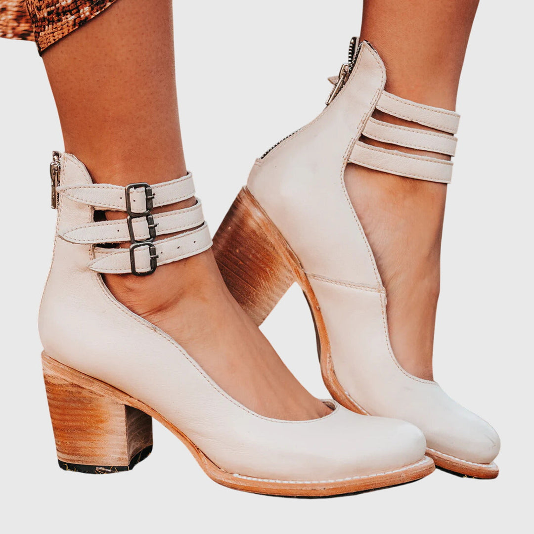 Western-inspired women's cutout ankle boots with stylish buckle, comfy block heel. Chic and on-trend footwear.