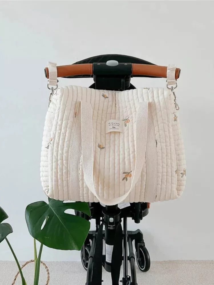 Women's chic embroidered hobo diaper bag, perfect for newborn essentials and stylish baby travel.