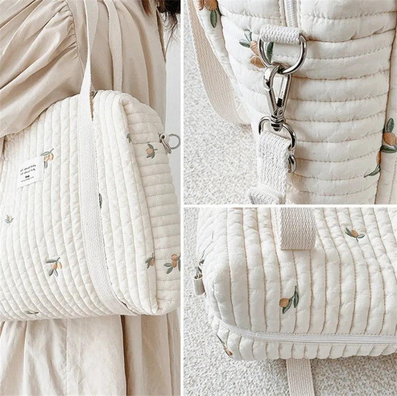 Embroidered hobo diaper bag for newborn essentials, stylish cotton design for modern moms.