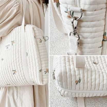 Embroidered hobo diaper bag for newborn essentials, stylish cotton design for modern moms.
