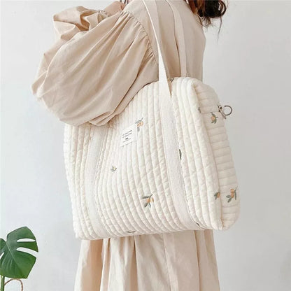 Embroidered hobo baby bag for newborn essentials, made from cotton, stylish for moms on the go.