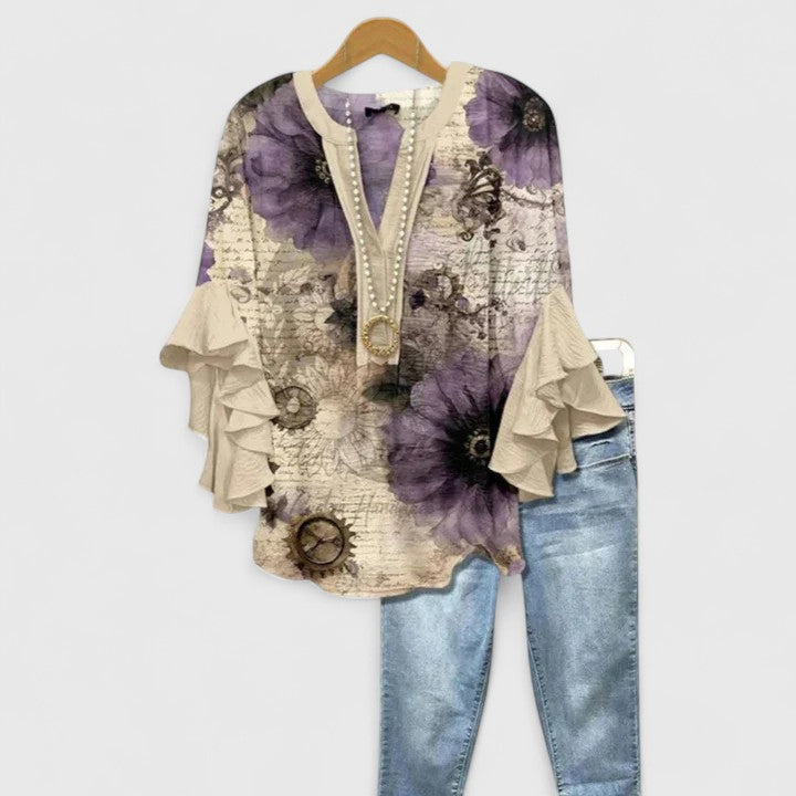 Women's fashionable floral print blouse. Chic long-sleeve top with elegant ruffled sleeves for versatile wear.