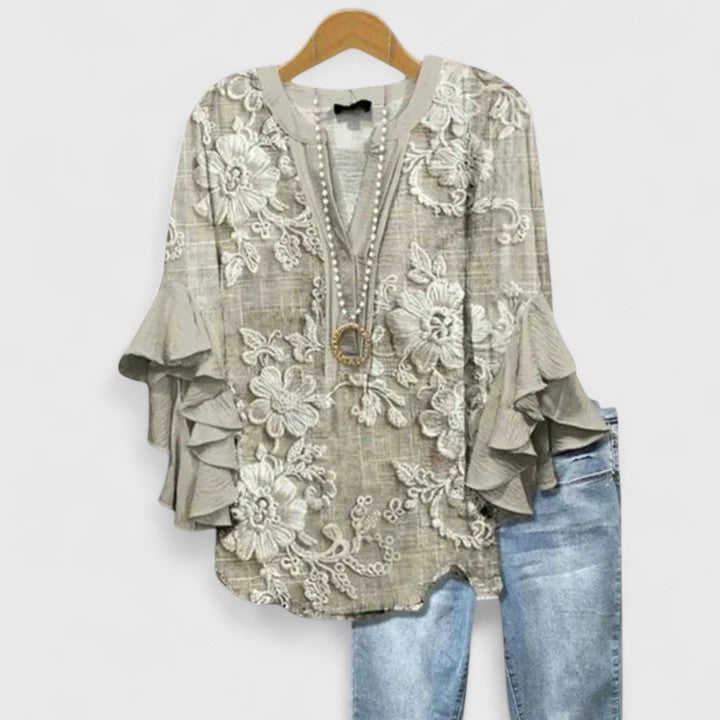 Elegant floral print women's top featuring stylish ruffled sleeves, ideal for casual or dressy occasions.
