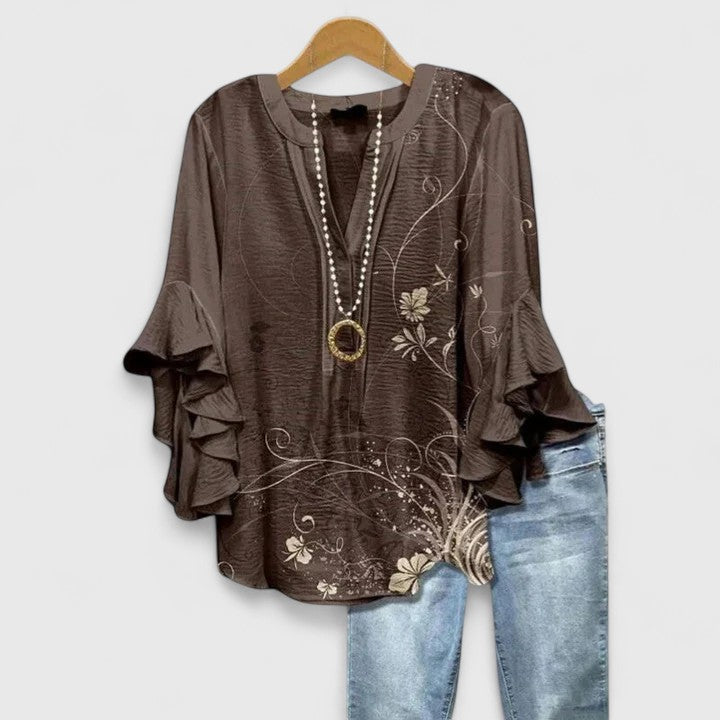 Chic women's floral print blouse with elegant ruffled sleeves, a versatile top for any season.