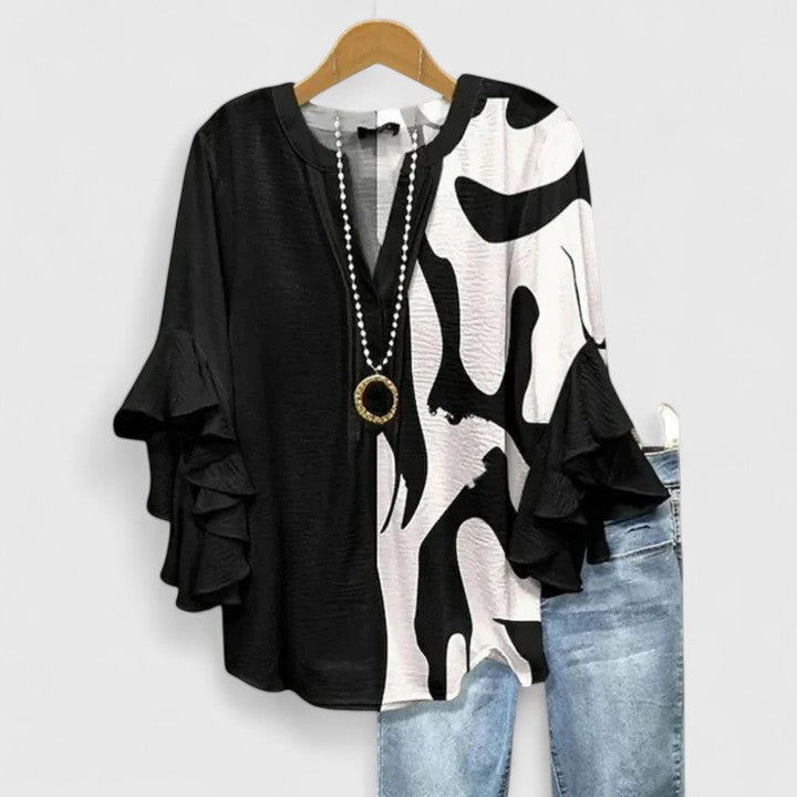 Stylish women's floral blouse with ruffled long sleeves. Comfortable & elegant for spring/summer fashion.