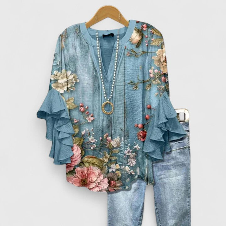Dressy women's floral print blouse, featuring delicate ruffled sleeves for an elegant fashion statement.