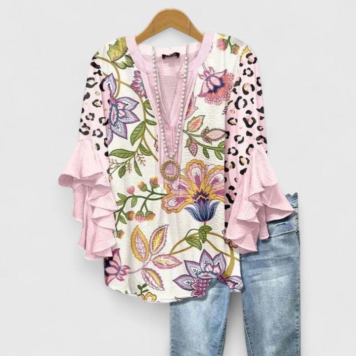 Women's elegant floral blouse. Comfortable long-sleeve top with chic ruffled sleeves for all occasions.