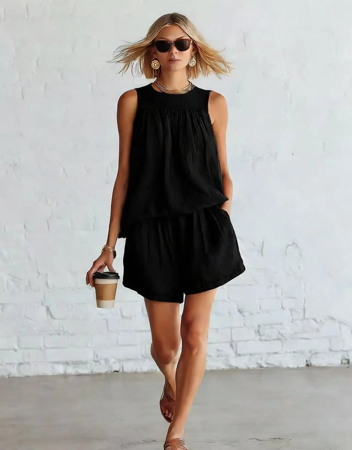Stylish women's summer two-piece: sleeveless gathered top & matching high-waisted shorts set. Casual chic.