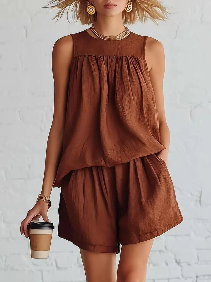 Chic women's two-piece ensemble: gathered sleeveless top & high-waisted shorts. Perfect for casual summer wear.