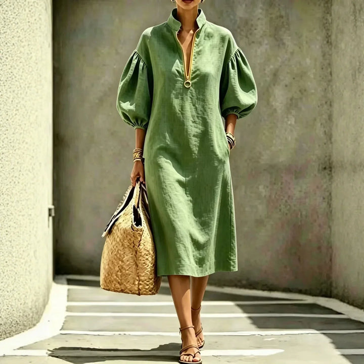 Stylish women's half-zip midi dress with fashionable bubble sleeves, offering a comfortable and chic look.