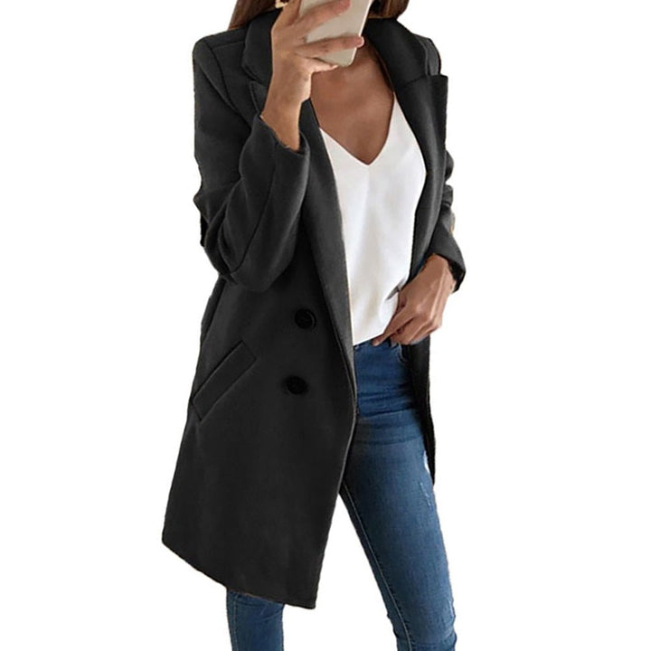 Woman in a chic long blazer coat, showcasing elegant and versatile outerwear style.